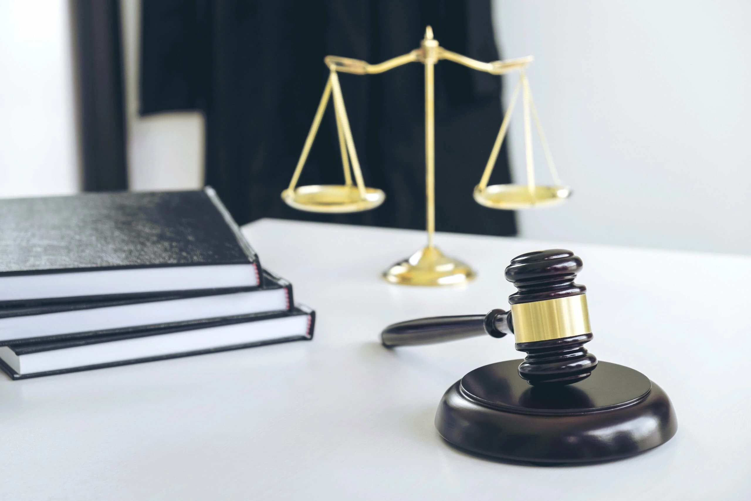 Certified court reporter's desk with gavel, scales of justice, and Legal Media Experts' video transcript notebooks in Atlanta, GA